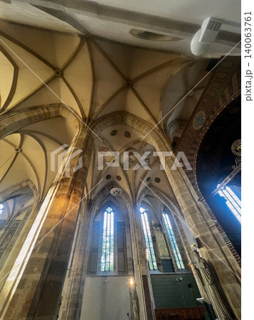 Gothic architecture of church interior with vaulted ceilings and stained glass Gothic architecture of church interior with vaulted ceilings and stained glass 140063761
