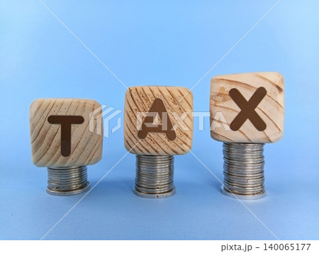 TAX illustration on wooden cubes. Business and finance concept. Selective focus TAX illustration on wooden cubes. Business and finance concept. Selective focus 140065177
