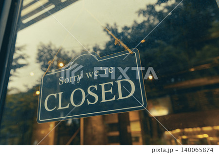 SORRY WE ARE CLOSED - Close sign broad hanging front of entrance door with copy space at coffee shop or restaurant SORRY WE ARE CLOSED - Close sign broad hanging front of entrance door with copy space at coffee shop or restaurant 140065874