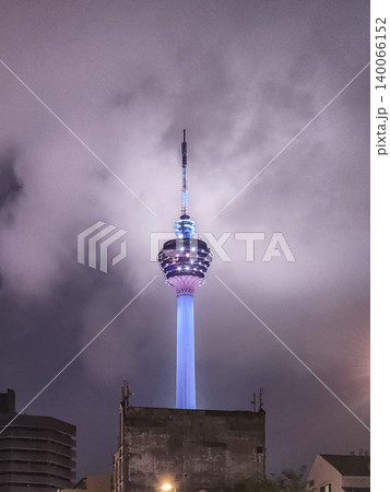 Menara KL Tower Illuminated at Night Against Cloudy Sky in Kuala Lumpur, Malaysia 140066152