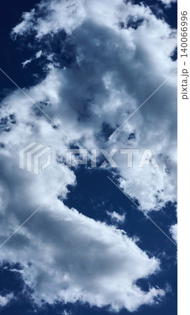 Bright white and soft grey clouds fill the expansive deep blue sky. They drift peacefully on a sunny day, creating a serene and natural atmospheric view Bright white and soft grey clouds fill the expansive deep blue sky. They drift peacefully on a sunny day, creating a serene and natural atmospheric view 140066996