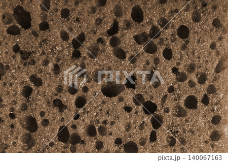Macro, closeup of brown foam sponge texture with porous, spongy and bubbly pattern background Macro, closeup of brown foam sponge texture with porous, spongy and bubbly pattern background 140067163