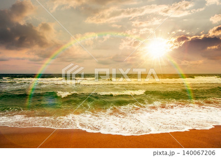 sunset over storm on the sandy beach. wonderful sea view with cloudy sky. salt water and crashing waves. view of bulgaria beach in summer. wind weather background under rainbow sunset over storm on the sandy beach. wonderful sea view with cloudy sky. salt water and crashing waves. view of bulgaria beach in summer. wind weather background under rainbow 140067206