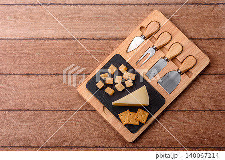 Aged cheese in a triangular block with jam, figs, and nuts. Aged cheese Aged cheese in a triangular block with jam, figs, and nuts. Aged cheese 140067214