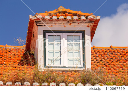Dormer window on traditional red tiled roof in Portugal 140067769