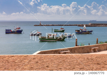 Fishing boats anchored in harbor near waterfront promenade Portugal Fishing boats anchored in harbor near waterfront promenade Portugal 140067770