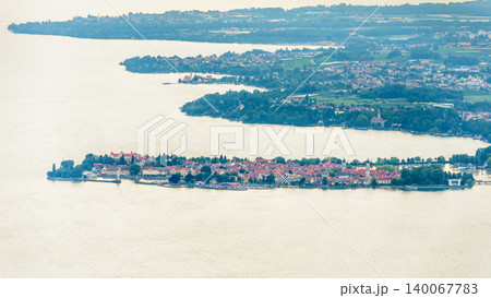 Aerial view of Lindau town on the island in Lake Constance. Panoramic landscape of Bodensee in Bavaria Germany. High angle view of historic buildings, red roofs and harbor Aerial view of Lindau town on the island in Lake Constance. Panoramic landscape of Bodensee in Bavaria Germany. High angle view of historic buildings, red roofs and harbor 140067783