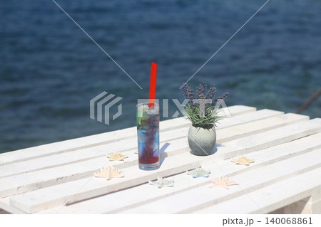 Summer cocktail on the background of the sea. Summer vacation, relaxation, summer party. Summer cocktail on the background of the sea. Summer vacation, relaxation, summer party. 140068861
