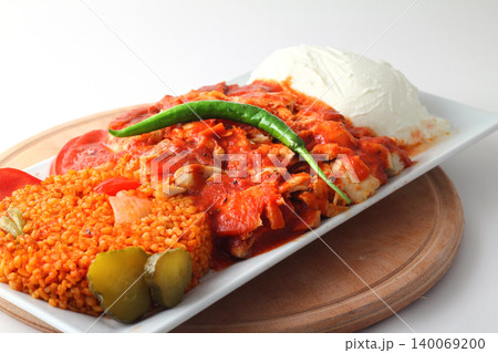 Turkish cuisine. Doner kebab meat with pommes frites potatoes and salad on plate isolated on white background 140069200