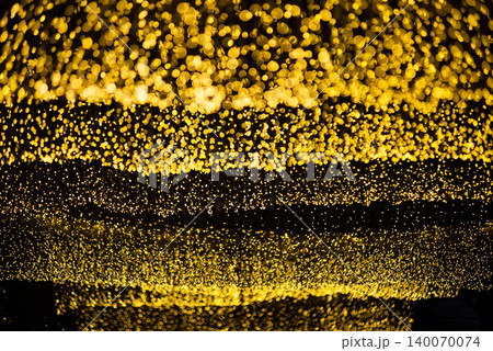 many bokeh from light bulb tubes on a street at night look like luxury golden starlight in a dark background many bokeh from light bulb tubes on a street at night look like luxury golden starlight in a dark background 140070074