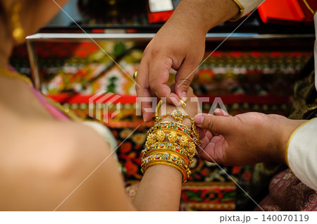 wedding rings together in hands 140070119