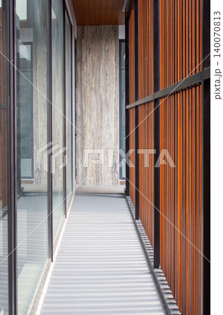 Semi outdoor corridor with shadowed concrete floor and marble wall. Semi outdoor corridor with shadowed concrete floor and marble wall. 140070813