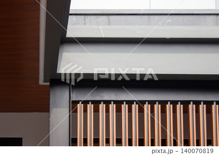 Modern building facade with brown wooden louvers and concrete beams. Modern building facade with brown wooden louvers and concrete beams. 140070819