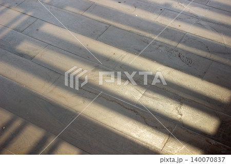 Gray tile floor texture with horizontal geometric shadow patterns. Gray tile floor texture with horizontal geometric shadow patterns. 140070837