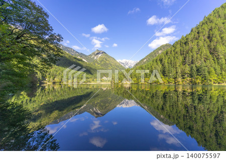 Amazing view of Mirror Lake with crystal clear water among mountains and evergreen woods in Jiuzhaigou nature reserve (Jiuzhai Valley National Park),China.  140075597