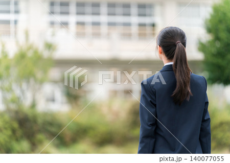 学校の校舎の前に立つ制服姿の中学生・高校生・小学生の後ろ姿 学校の校舎の前に立つ制服姿の中学生・高校生・小学生の後ろ姿 140077055