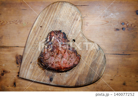 Cooked T-bone steak on wooden board Cooked T-bone steak on wooden board 140077252