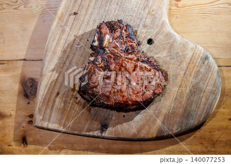 Cooked T-bone steak on wooden board Cooked T-bone steak on wooden board 140077253
