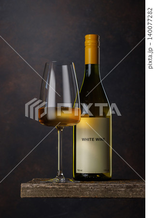 Wine glass and bottle with white wine 140077282