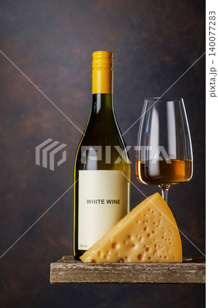 White wine glass with cheese on rustic table White wine glass with cheese on rustic table 140077283