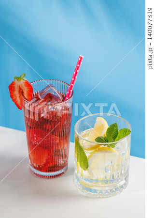 Fresh strawberry and lemon non alcoholic drinks with mint on blue background Fresh strawberry and lemon non alcoholic drinks with mint on blue background 140077319