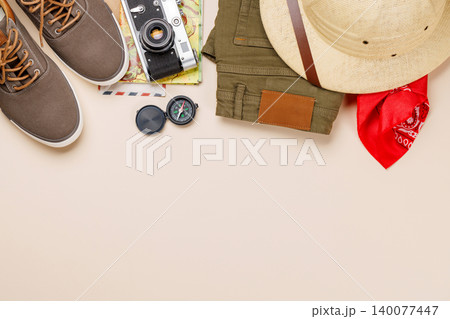 Safari clothing and gear on beige background Safari clothing and gear on beige background 140077447