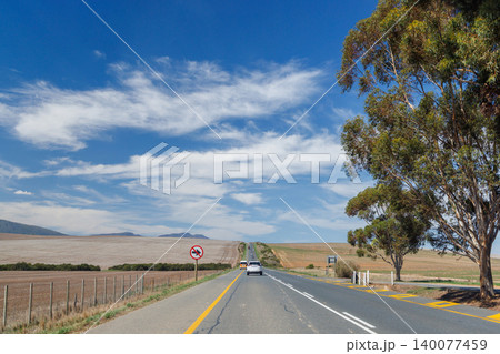 Asphalt road in South Africa surrounded by fields 140077459