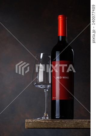 Red bottle with white wine Red bottle with white wine 140077489