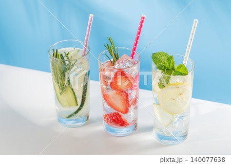 Set of fresh non alcoholic drinks with strawberry cucumber and lemon on blue background 140077638