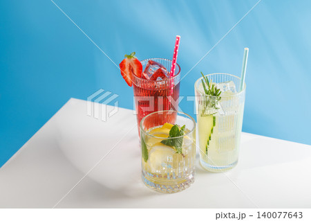 Assortment of non alcoholic refreshing drinks with herbs and citrus on blue background 140077643