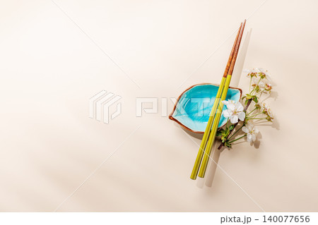 Minimal asian composition with chopsticks and blossom branch 140077656