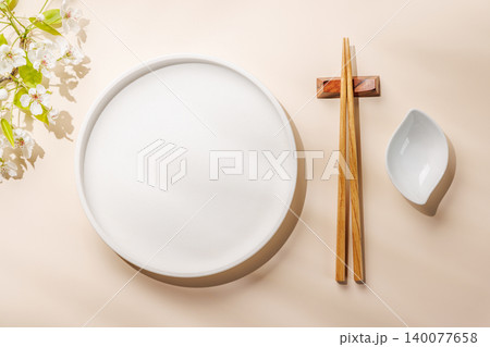 Empty white plate with chopsticks and blue bowl Empty white plate with chopsticks and blue bowl 140077658