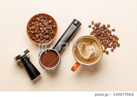 Espresso coffee setup with beans tamper and portafilter top view 140077668