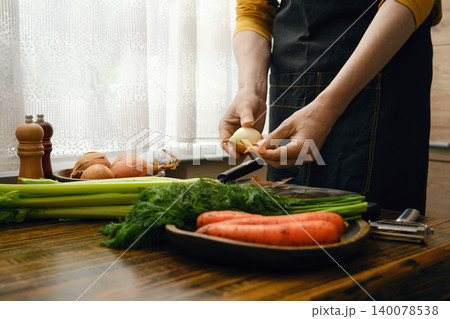 Cooking vegetables in a kitchen with fresh produce during the day Cooking vegetables in a kitchen with fresh produce during the day 140078538