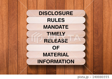 Disclosure Rules Mandate Timely Release Of Material Information tagline written on wooden stick with wooden texture background, business and investment, stock market theme, copy space 140080355
