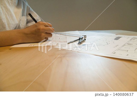 設計図面を確認する手元と建築道具 140080637
