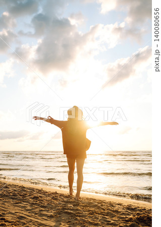 Beautiful woman enjoying a summer day on the beach at sunset. Lifestyle, tourism, active life. Beautiful woman enjoying a summer day on the beach at sunset. Lifestyle, tourism, active life. 140080656
