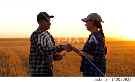 farmer makes deal to buy farmland. handshake of farmers them as a symbol of the deal of purchase and sale. purchase and sale of farmland farmer makes deal to buy farmland. handshake of farmers them as a symbol of the deal of purchase and sale. purchase and sale of farmland 140080927