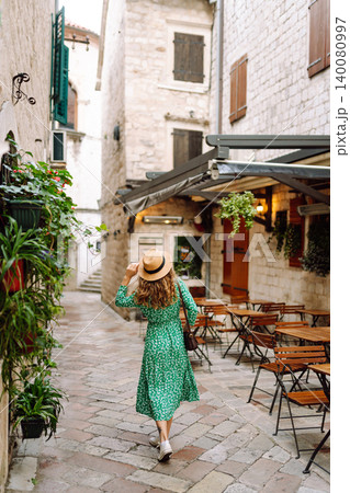 Young beautiful woman in trendy summer dress posing in street. Fashion style. Tourist attraction. 140080997