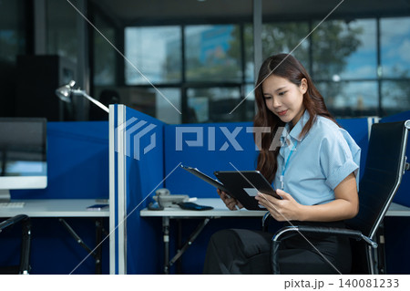 Send a message to a colleague, a businessman, confident in matching a tablet and sitting in office. Send a message to a colleague, a businessman, confident in matching a tablet and sitting in office. 140081233