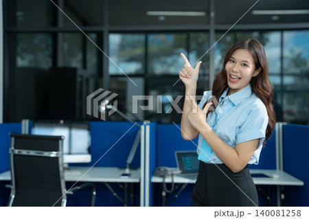 Happy young businesswoman presenting or pointing, happy working. Happy young businesswoman presenting or pointing, happy working. 140081258