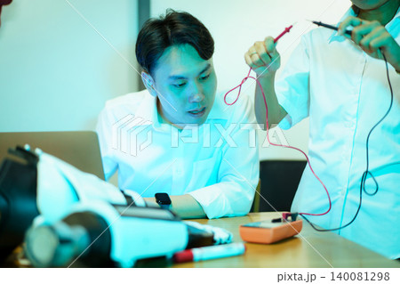 Asian university students working on robotics STEM project in lab 140081298