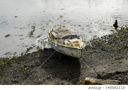 Old boats on the shore line in various state of decay Old boats on the shore line in various state of decay 140082118