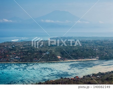 Volcanic island landscape with coastline and volcano mountain in tropical haze Volcanic island landscape with coastline and volcano mountain in tropical haze 140082149