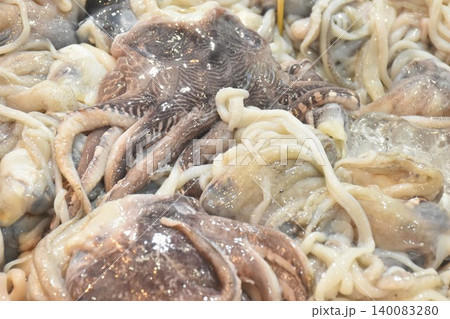 raw squid ingredient food topping ice for fresh keeping on refrigerator displays at supermarket 140083280