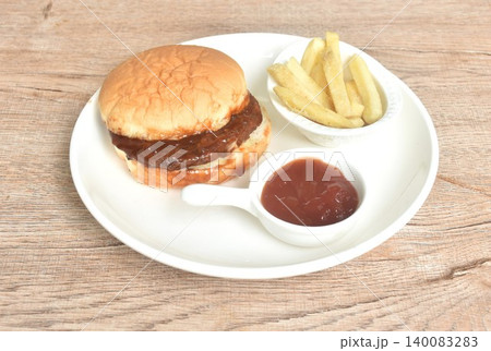 fried mashed beef meat hamburger dressing barbecue sauce with crispy French fries dipping ketchup on plate fried mashed beef meat hamburger dressing barbecue sauce with crispy French fries dipping ketchup on plate 140083283