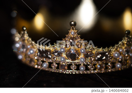 Golden crown with light reflections on black background, luxury and power concept. Golden crown with light reflections on black background, luxury and power concept. 140084002