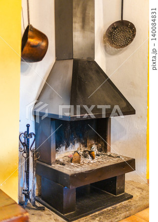 Traditional Mediterranean fireplace in historic country house interior Traditional Mediterranean fireplace in historic country house interior 140084831