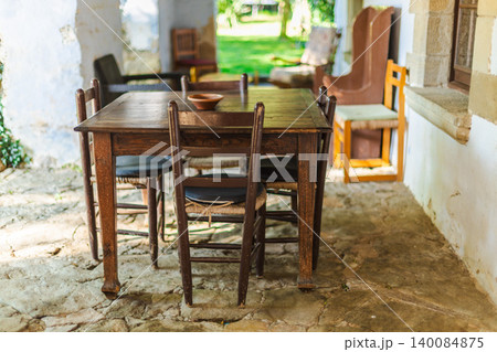 Rustic Mediterranean dining table on traditional country house veranda 140084875