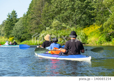 Family in a Varzuga kayak on open water, family river route, active summer leisure. 140085154